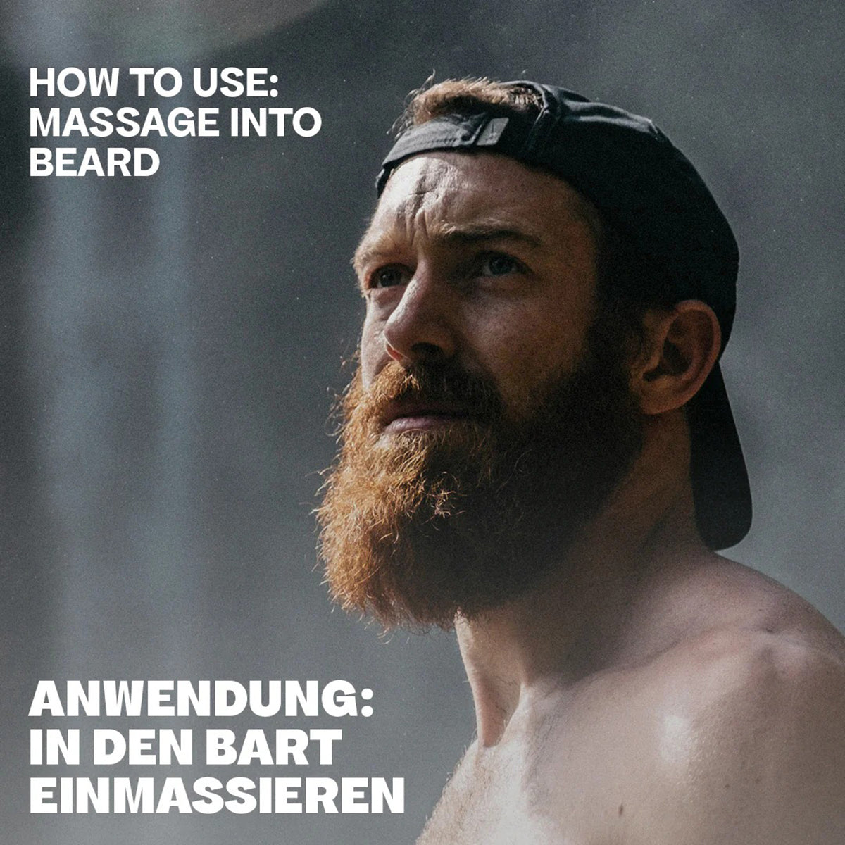 Mand med fuld, rødbrun skæg og kasket viser brugen af Bali Gents Beard Oil 30ml ved at massere den ind i skægget.